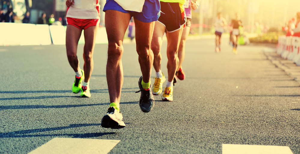 Marathon running race, people feet on city road