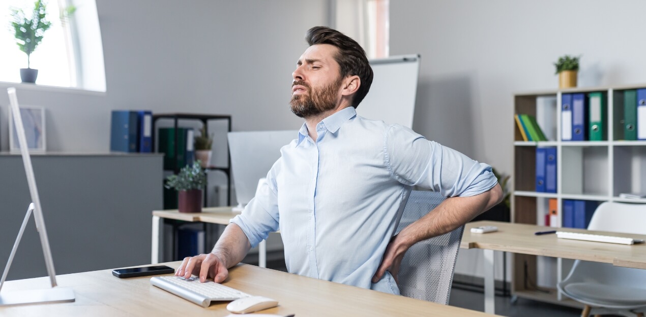 An image of a person suffering from low back pain from sitting